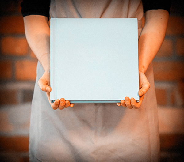 Woman holding album for display