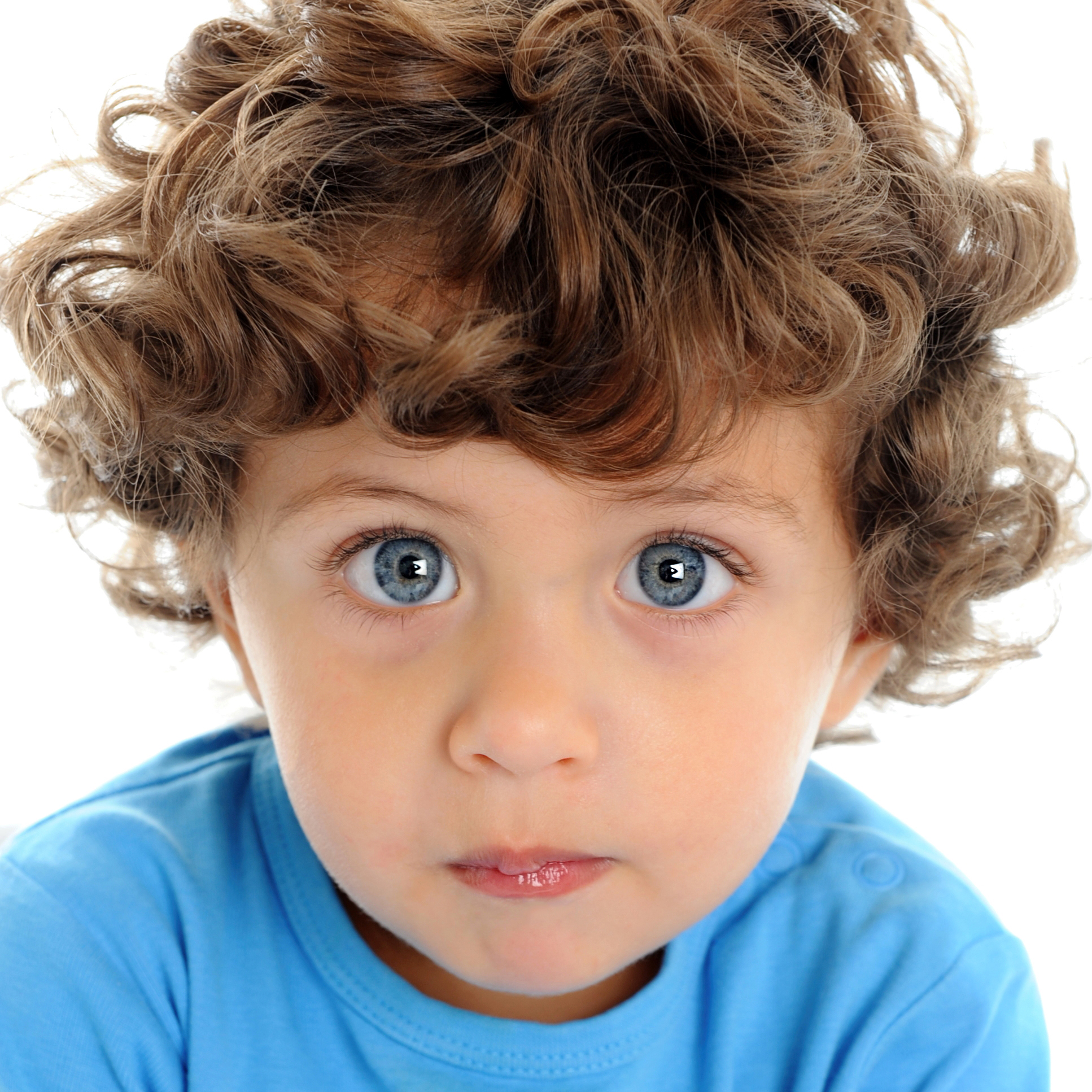 Toddler with big blue eyes in blue t-shirt